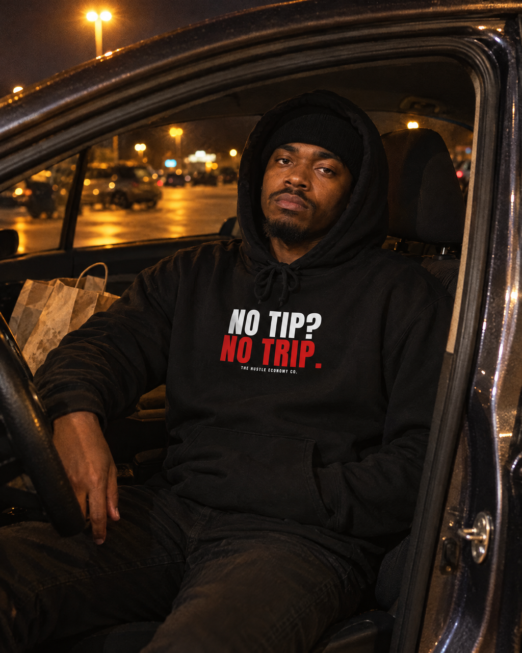 Driver in the No Tip? No Trip. black hoodie sitting in his car at night